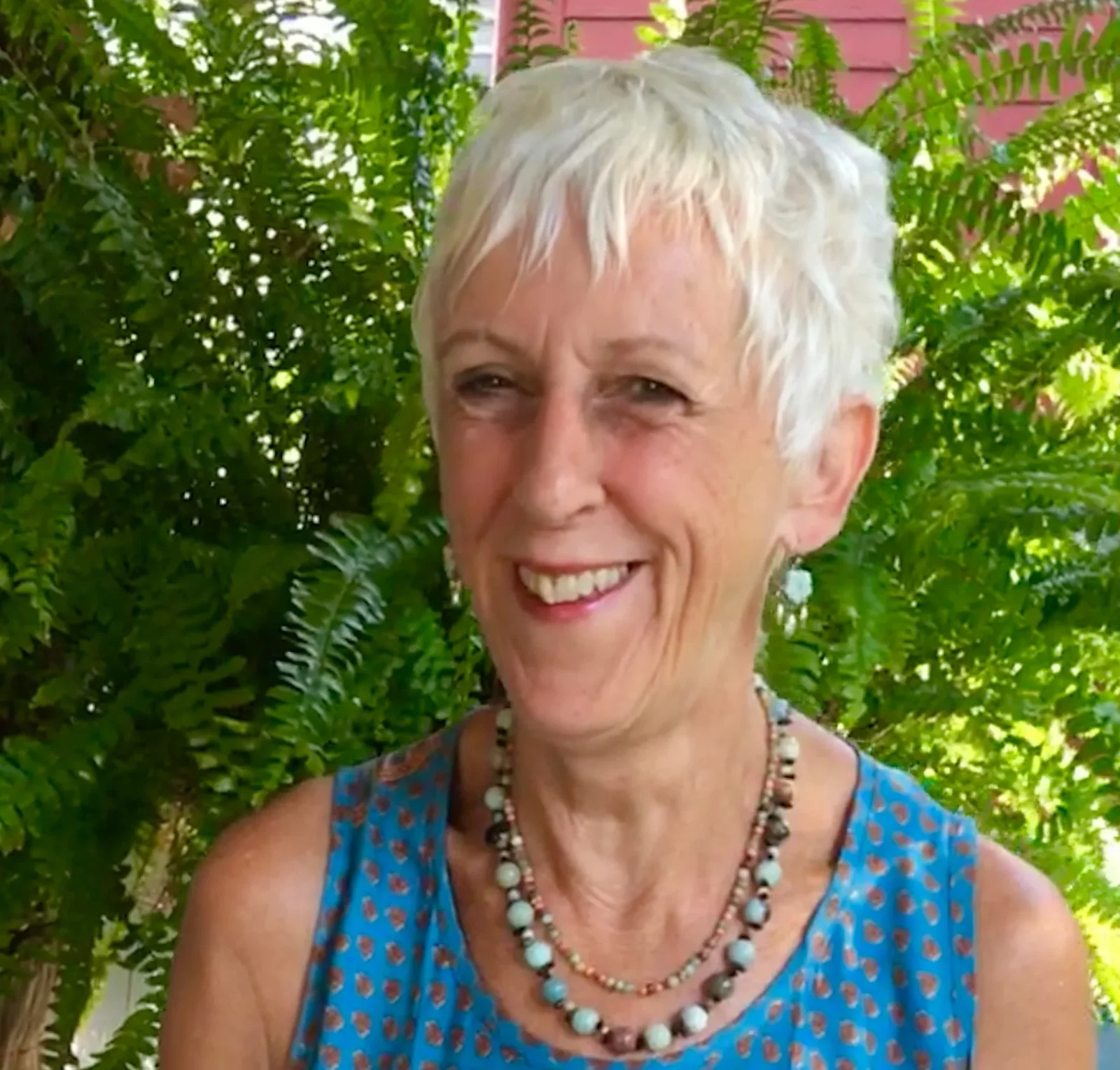 Raphaela McCormack smiling in front of green ferns