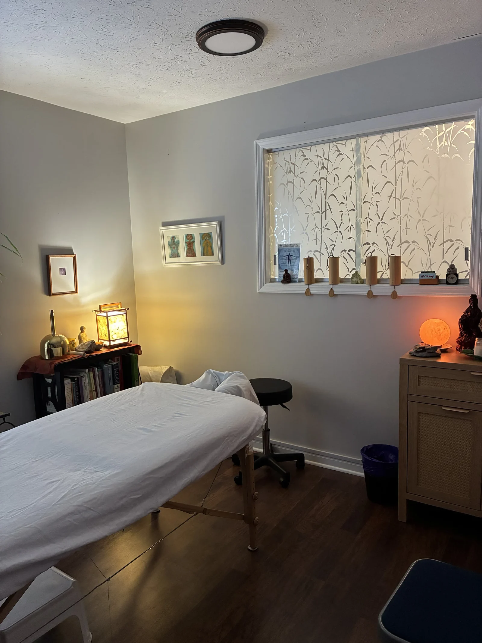 Treatment room with a patterned window and wind chimes